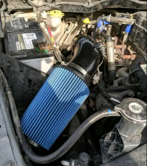 The EVIL ENERGY 6.7 Cummins air intake installed in a Dodge Ram with Cummins engine bay, showing the blue diesel cold air intake filter.